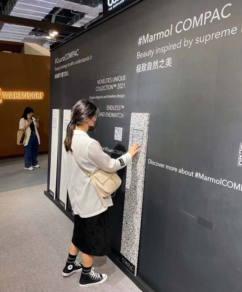 A visitor at COMPAC's stand at Design Shanghai 2021.